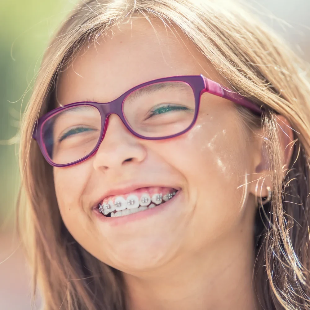 Child smiling with braces during orthodontic treatment