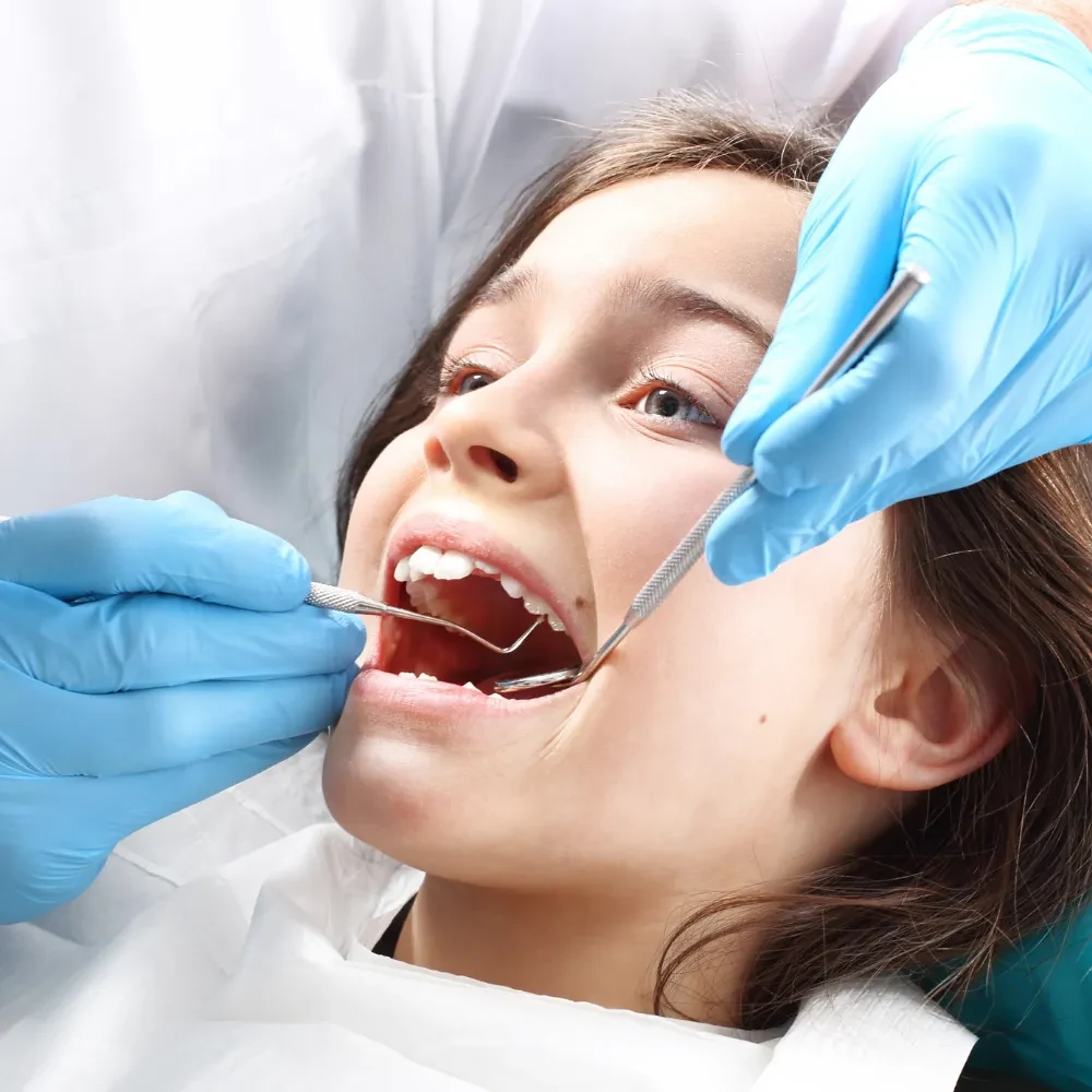 Child receiving dental care and sealants to prevent cavities
